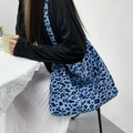 Detail of blue leopard print corduroy tote bag showing large capacity worn by model - With Lining And Zipper / Blue Leopard