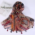 Detailed view of bohemian style shawl with colorful geometric patterns and red fringe - Style 26