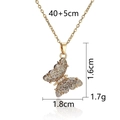 Golden butterfly pendant necklace with white crystals on a white reflective surface - Gold Zirconia Paved Butterfly Necklace