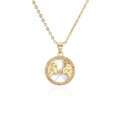 Macro shot of gold constellation necklace with orange cubic zirconia and mother of pearl - Gemini