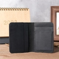 Macro view of interior card slots in a vintage black genuine leather wallet on wood - 1052 Black