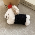 Detailed view of a cute plush puppy hair clip with soft lamb wool texture and red ball detail - Black and White Patchwork Lamb Wool Dog (Duckbill Clip)