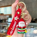 Simpatico portachiavi di Babbo Natale con cinturino in silicone rosso e chiusura dorata - Borsa gialla (Babbo Natale con borsa)