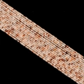 Transparent crystal block beads with reddish inclusions on a woven jewelry strand - Red Hematoid Quartz