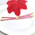 Detail of pink woven Milan cord bracelet featuring adjustable gold-plated beads and clasp - Pink