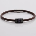 Detail of brown braided leather bracelet featuring a purple stone and magnetic clasp - Brown Leather + Purple Stone