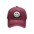 Detailed macro view of the vintage washed cotton fabric and smiley face embroidery on hat - Adult / Burgundy