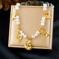 Close-up of gold-plated necklace with white pearls and diverse music-themed charms - Musical Note Cross Instrument Style (N3745)