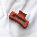 Elegant matte orange-red hair claw clip for women on soft white fabric background - Brick Red