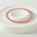 Macro detail of a 4mm rose gold beaded elastic bracelet with dimension and weight specs - 4mm / Rose Gold