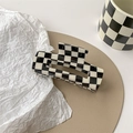 Close-up of black and white checkerboard hair claw clip with modern cutout design - Large Square Claw