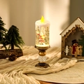 Detailed shot of a festive Christmas water candle lamp featuring a Santa Claus figurine - Santa Waving Style / Brushed Gold