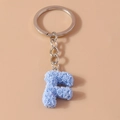 Blue rose pattern letter F keychain with silver metal ring on pink background - Letter F