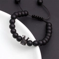 Macro detail of black matte stone beads and micro-paved crown charm on woven bracelet - Black Frosted Crown Style