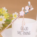Close-up of a floral hair stick with pink petals, blue rhinestones, and long pearl tassels - Rose Gold Pink Flower Blue Rhinestone Tassel (FZ014)
