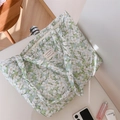 Close-up of green floral quilted cotton tote bag with white French logo patch detail - Green Gardenia