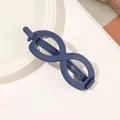 Detail showing the matte navy blue infinity-shaped hair claw clip on a stylish background - Infinity - Royal Blue