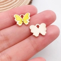 Detailed view of yellow butterfly pendant showing enamel finish and textured metal back - Butterfly