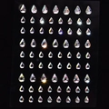 Macro shot of 56 teardrop AB crystal facial gems for makeup and nail art decoration - MX-28 Large Small Teardrop