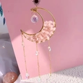 Handmade crescent moon suncatcher with rose quartz stones and crystal accents on pink background - M1-Rose Quartz