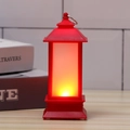 Close-up of red Christmas LED lantern with warm candle flame effect and metal hanging ring - Red