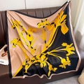 Detailed view of the yellow iris floral print on a luxurious silk-feel large square scarf - 90cmx90cm / Yellow