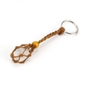 Detailed macro view of a handmade woven net keychain holding a natural clear crystal stone - Brown Rope + Clear Quartz