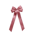 Detailed view of pink satin ribbon bow hair clip with elegant long streamers on white base - Pink