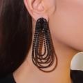 Luxurious long tassel drop earrings featuring multi-layered black rhinestones on model - Black Multi-Layer Teardrop / Black