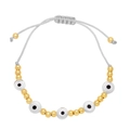 Close-up of bohemian evil eye woven bracelet with gold beads and adjustable grey cord - Gray