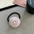 Detail of a pink velvet rose flower hair scrunchie with a black elastic hair tie band - Light Pink