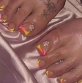 French gradient toe nails with yellow, orange, pink tips and white flower pattern - FW21