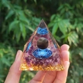Orgone pyramid with amethyst crystals and gold foil held in natural lighting - 6cm / A19-Amethyst Sacred Geometry