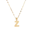 Macro shot of gold letter Z pendant featuring unique textured dot pattern on a fine chain - Letter Z