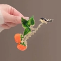 Detail of hand-painted persimmon hair claw clip with a bird on a bronze branch - L14 Double Persimmon