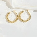 French vintage style gold beaded ribbed round earrings on a white silk and stone backdrop - Hoop Style