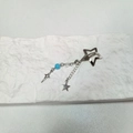 Silver star hair clip with blue bead tassel chain and star pendants on a white stone - Blue Beads Star