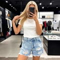 Women's light blue distressed denim shorts with ripped holes and frayed hemline - S / Light Blue