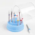 Macro shot of 10 nail drill bits with ceramic heads and a blue circular storage stand - 48-Hole Small Box with Drill Bits / Blue