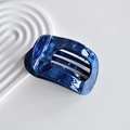Close-up of a blue marble texture square acetate hair claw clip on a white wavy background - 9# Dark Blue Pearlescent Acetate Circular Claw