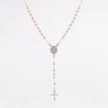 Macro view of champagne beaded necklace with Virgin Mary medal and silver cross pendant - Beige