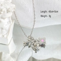 Detailed shot of titanium steel necklace featuring airplane and suitcase charms - Silver - Globe Airplane Necklace