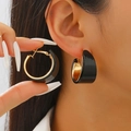 Macro view of chunky gold and black wide C-shape hoop earrings on model ear - KC Gold Black (4919)
