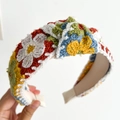 Knitted headband with colorful embroidered flowers held by hand to show side detail - Yellow Flower Knotted Knitted Headband