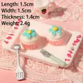 Miniature dollhouse resin cupcakes on a white relief tray with tiny silver cutlery detail - Flower Cake