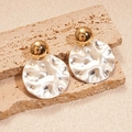 Detail view of gold sphere and silver hammered metal disc drop earrings on stone - Silver Earring Post - Gold & Silver Tone