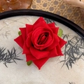 Close-up of velvet red rose hair clip with green leaves on traditional ink bamboo plate - Large Red Flower