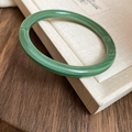 Macro detail of green marbled resin bangle with polished finish on jewelry box - 62# Bracelet-Emerald Floating Flower Round