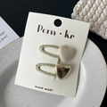 Chic two-piece heart hair clip set in gold and cream white finish on a display card - Heart Hair Clip Set