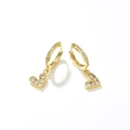 Minimalist gold heart earrings with sparkling cubic zirconia on a white background - White